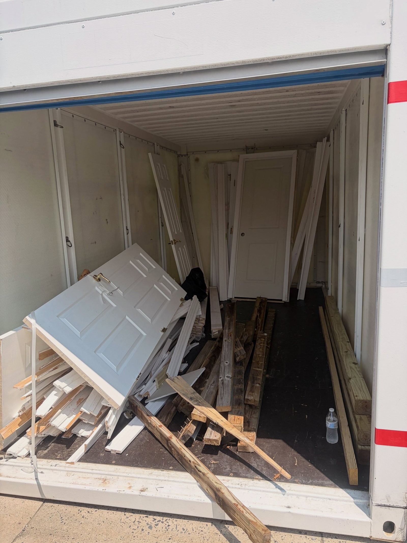 Storage container full of doors and lumber before cleanout