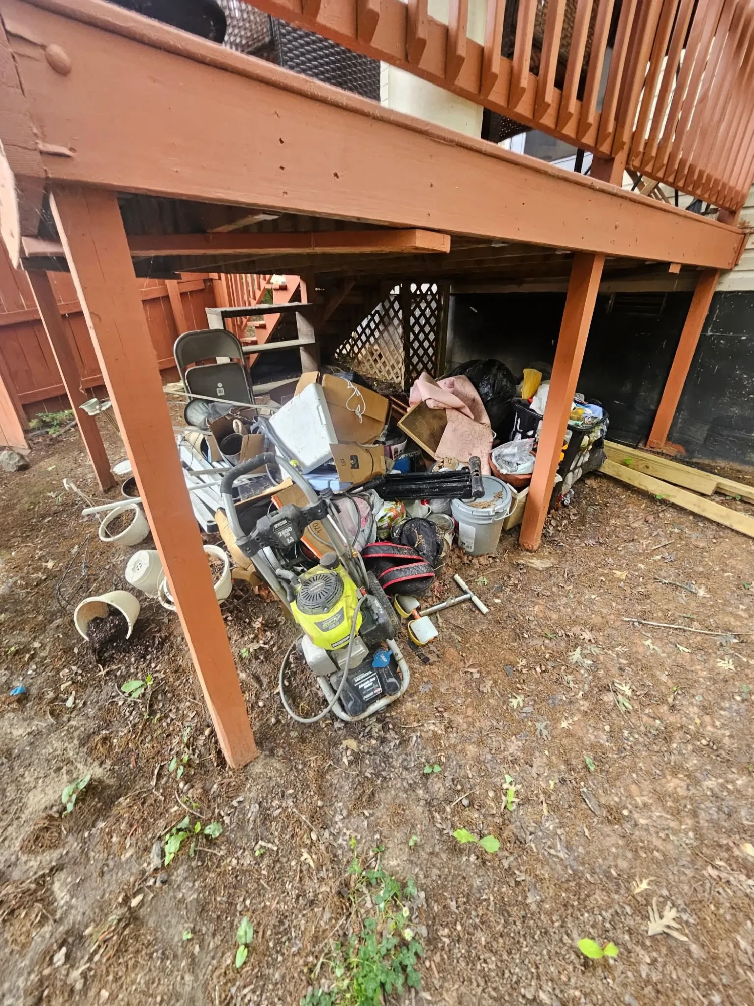 Under-deck storage area full of junk before cleanout